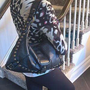 Black leather Isabella Fiore bag with brass accents.